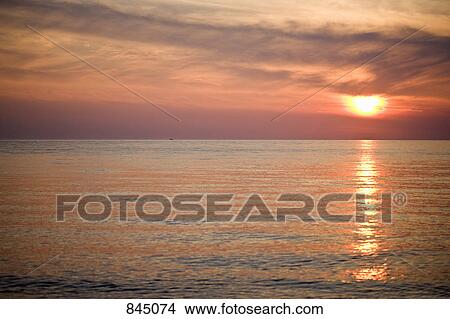 Picture - A sunset over a lake. Fotosearch