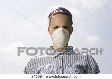 A young woman wearing a pollution mask View Large Photo Image Picture - A young woman wearing a pollution mask. Fotosearch