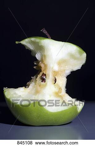 Stock Photo - An eaten green apple. Fotosearch