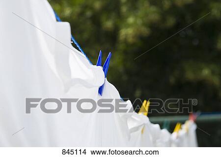 Sheets drying on a clothesline, close-up View Large Photo Image Picture - Sheets drying on a clothesline, close-up. Fotosearch