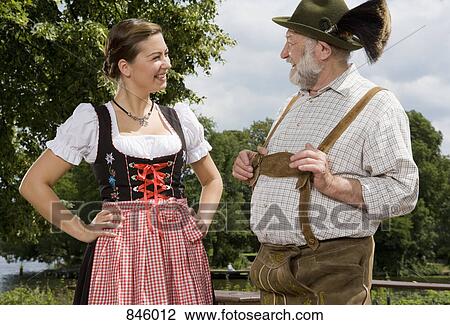A traditionally clothed German man and woman in a beer garden View Large Photo Image Stock Image - A traditionally clothed German man and woman in a beer garden. Fotosearch
