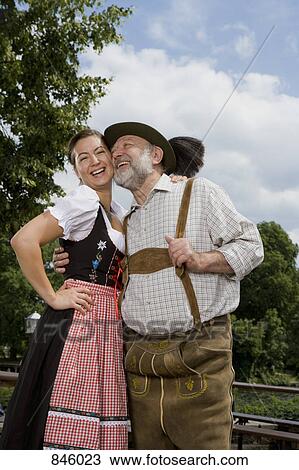 A traditionally clothed German man and woman in a beer garden View Large Photo Image Stock Image - A traditionally clothed German man and woman in a beer garden. Fotosearch