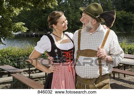 A traditionally clothed German man and woman in a beer garden View Large Photo Image Stock Image - A traditionally clothed German man and woman in a beer garden. Fotosearch