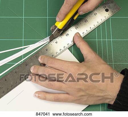Detail of a person cutting paper View Large Photo Image Stock Image - Detail of a person cutting paper. Fotosearch