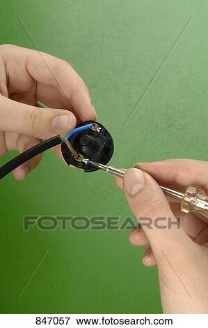 Detail of a woman holding a screwdriver and a cable View Large Photo Image Stock Photo - Detail of a woman holding a screwdriver and a cable. Fotosearch