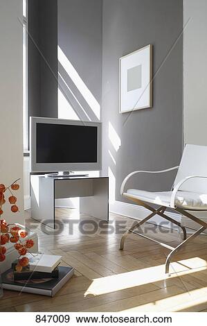 Stock Photo - Television and arm chair in a modern living room. Fotosearch