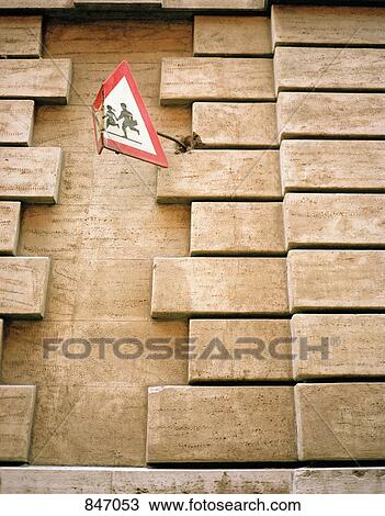 Wall with a bent sign for a school crossing View Large Photo Image Stock Image - Wall with a bent sign for a school crossing. Fotosearch