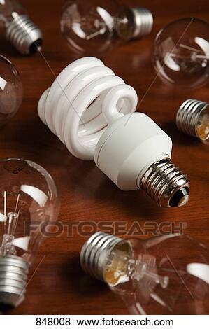 An energy saving light bulb among a group of filament light bulbs View Large Photo Image Stock Photo - An energy saving light bulb among a group of filament light bulbs. Fotosearch