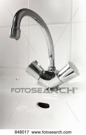 Water dripping from a bathroom faucet View Large Photo Image Stock Photo - Water dripping from a bathroom faucet. Fotosearch