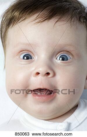 Stock Image - A baby girl making a funny face. Fotosearch