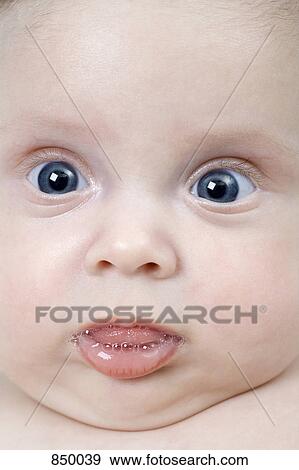 Stock Photo - A baby girl making a funny face. Fotosearch