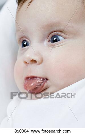 A baby girl sticking out her tongue View Large Photo Image Picture - A baby girl sticking out her tongue. Fotosearch