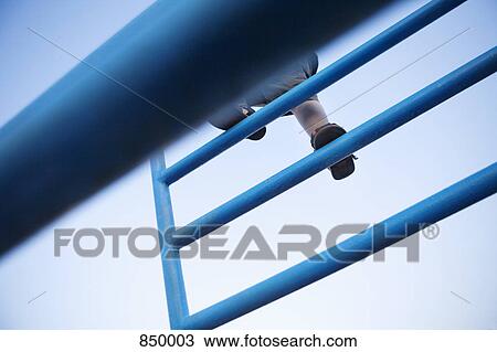 Stock Image - A child climbing on a jungle gym. Fotosearch