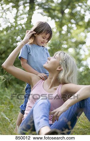 A mother and daughter in a field View Large Photo Image Stock Image - A mother and daughter in a field. Fotosearch