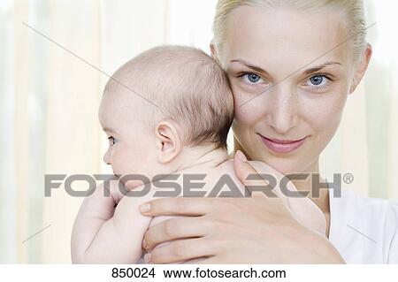 A mother holding her baby daughter View Large Photo Image Picture - A mother holding her baby daughter. Fotosearch
