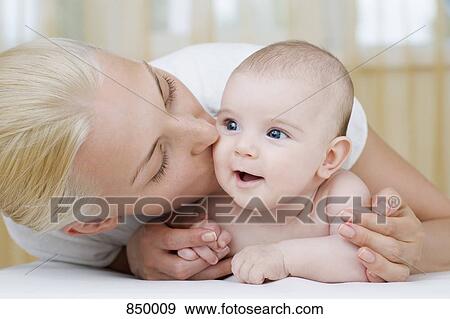 A mother kissing her baby daughter View Large Photo Image Stock Photo - A mother kissing her baby daughter. Fotosearch