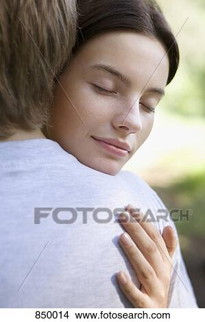 A young couple embracing View Large Photo Image Picture - A young couple embracing. Fotosearch