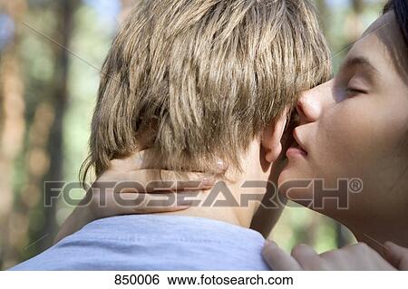 A young couple embracing View Large Photo Image Stock Photograph - A young couple embracing. Fotosearch