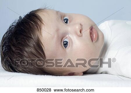 Portrait of a baby girl lying down View Large Photo Image Stock Photo - Portrait of a baby girl lying down. Fotosearch