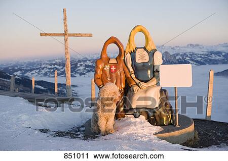 Two life size cut out stand in figures and a dog during sunset on Mount Rigi, Switzerland View Large Photo Image Stock Image - Two life size cut out stand in figures and a dog during sunset on Mount Rigi, Switzerland. Fotosearch