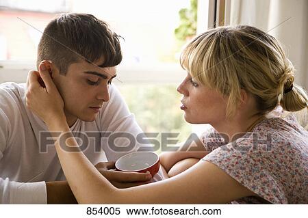 A girlfriend comforting her boyfriend View Large Photo Image Stock Photography - A girlfriend comforting her boyfriend. Fotosearch