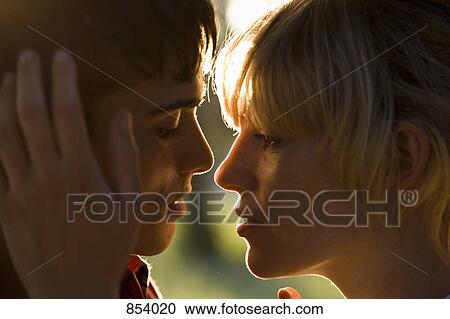 Stock Image - A passionate young couple face to face, extreme close up. Fotosearch