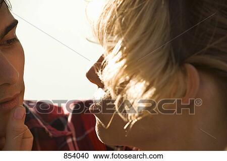 Stock Image - A passionate young couple face to face, extreme close up. Fotosearch
