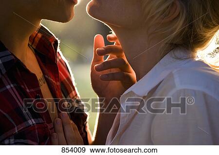 A passionate young couple face to face, extreme close up View Large Photo Image Stock Photo - A passionate young couple face to face, extreme close up. Fotosearch