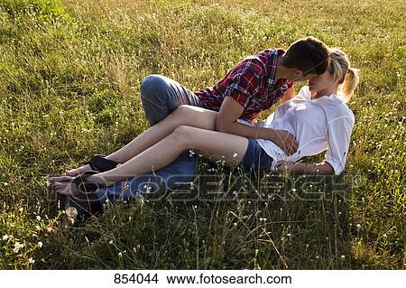 A young affectionate couple in a park View Large Photo Image Picture - A young affectionate couple in a park. Fotosearch