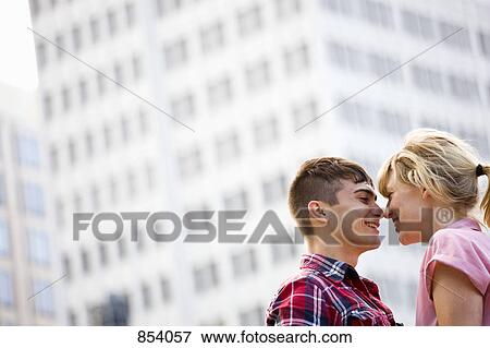 Stock Photo - A young affectionate couple in an urban setting. Fotosearch