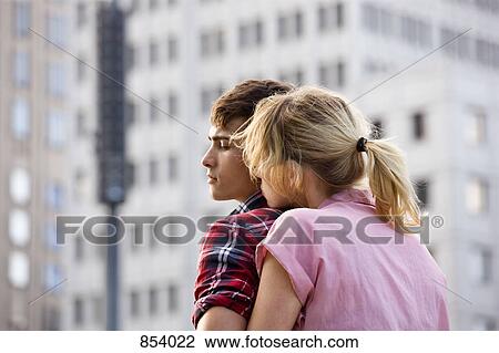 A young couple embracing in an urban setting View Large Photo Image Stock Image - A young couple embracing in an urban setting. Fotosearch