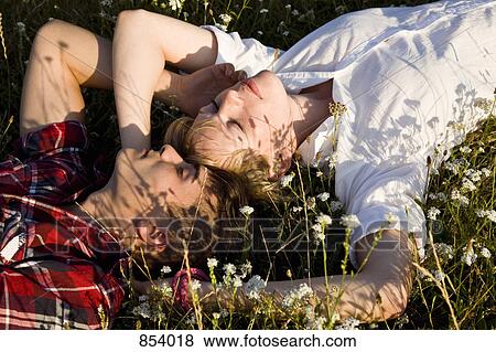 A young couple napping in a field View Large Photo Image Stock Photo - A young couple napping in a field. Fotosearch