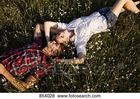 A young couple napping in a field View Large Photo Image Stock Photo - A young couple napping in a field. Fotosearch