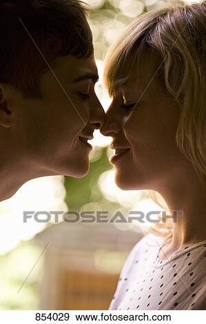 A young couple rubbing noses View Large Photo Image Stock Photo - A young couple rubbing noses. Fotosearch