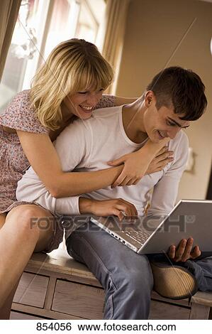 A young couple using a laptop together View Large Photo Image Stock Photograph - A young couple using a laptop together. Fotosearch