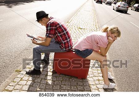 A young couple with a suitcase and a map View Large Photo Image Stock Photo - A young couple with a suitcase and a map. Fotosearch