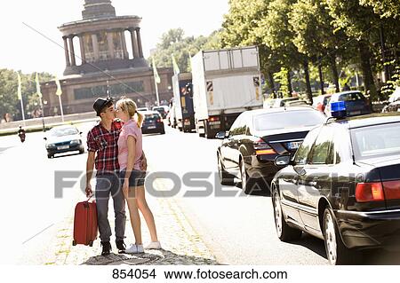 A young couple with a suitcase kissing View Large Photo Image Picture - A young couple with a suitcase kissing. Fotosearch