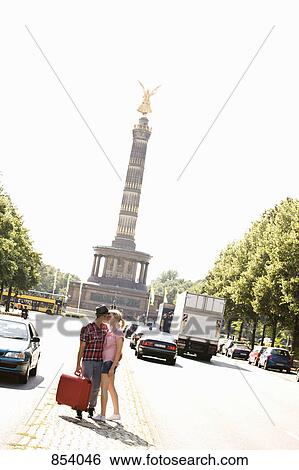 A young couple with a suitcase kissing View Large Photo Image Stock Photograph - A young couple with a suitcase kissing. Fotosearch