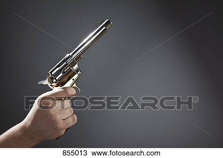 Stock Image - A hand holding a pistol. Fotosearch