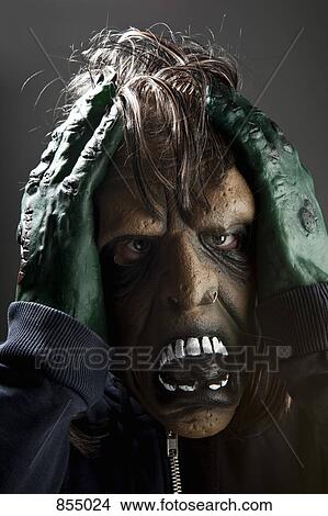 Picture - A person wearing a spooky disguise. Fotosearch