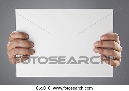 Hands holding up a white piece of paper View Large Photo Image Stock Photograph - Hands holding up a white piece of paper. Fotosearch