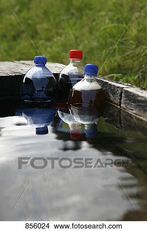 Plastic bottles of soda submerged in a trough of water View Large Photo Image Picture - Plastic bottles of soda submerged in a trough of water. Fotosearch