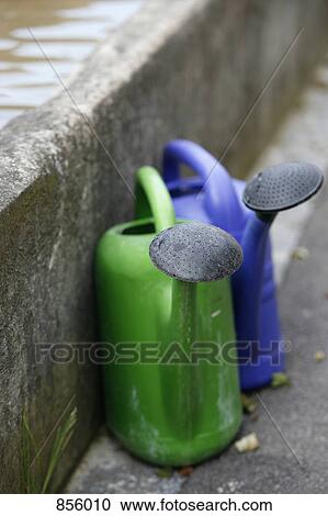 Stock Image - Two plastic watering cans. Fotosearch