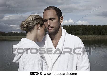 A couple in bathrobes near a lake at a health spa View Large Photo Image Stock Photo - A couple in bathrobes near a lake at a health spa. Fotosearch
