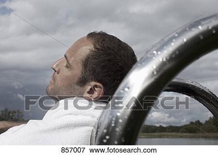 A man in a bathrobe relaxing with his eyes closed View Large Photo Image Stock Photo - A man in a bathrobe relaxing with his eyes closed. Fotosearch
