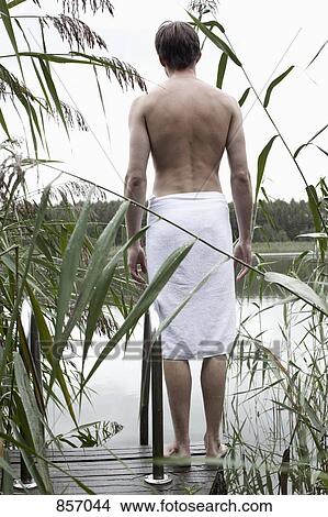 A man standing on a spa jetty staring off into the distance View Large Photo Image Picture - A man standing on a spa jetty staring off into the distance. Fotosearch
