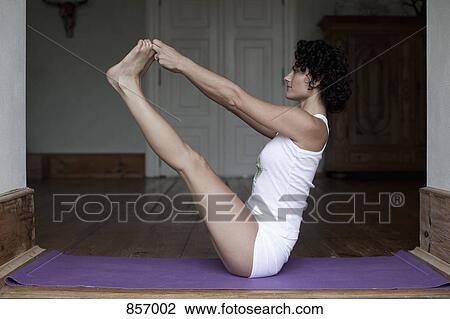 A woman doing the yoga boat pose View Large Photo Image Stock Image - A woman doing the yoga boat pose. Fotosearch