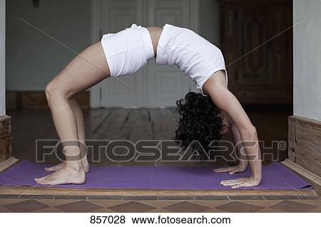 A woman doing the yoga bridge position View Large Photo Image Stock Photo - A woman doing the yoga bridge position. Fotosearch