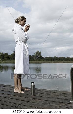 A woman in a bathrobe standing on a health spa jetty View Large Photo Image Stock Image - A woman in a bathrobe standing on a health spa jetty. Fotosearch