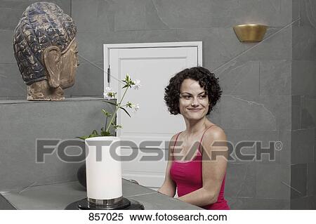 Stock Photography - A woman in a bathroom at a health spa. Fotosearch